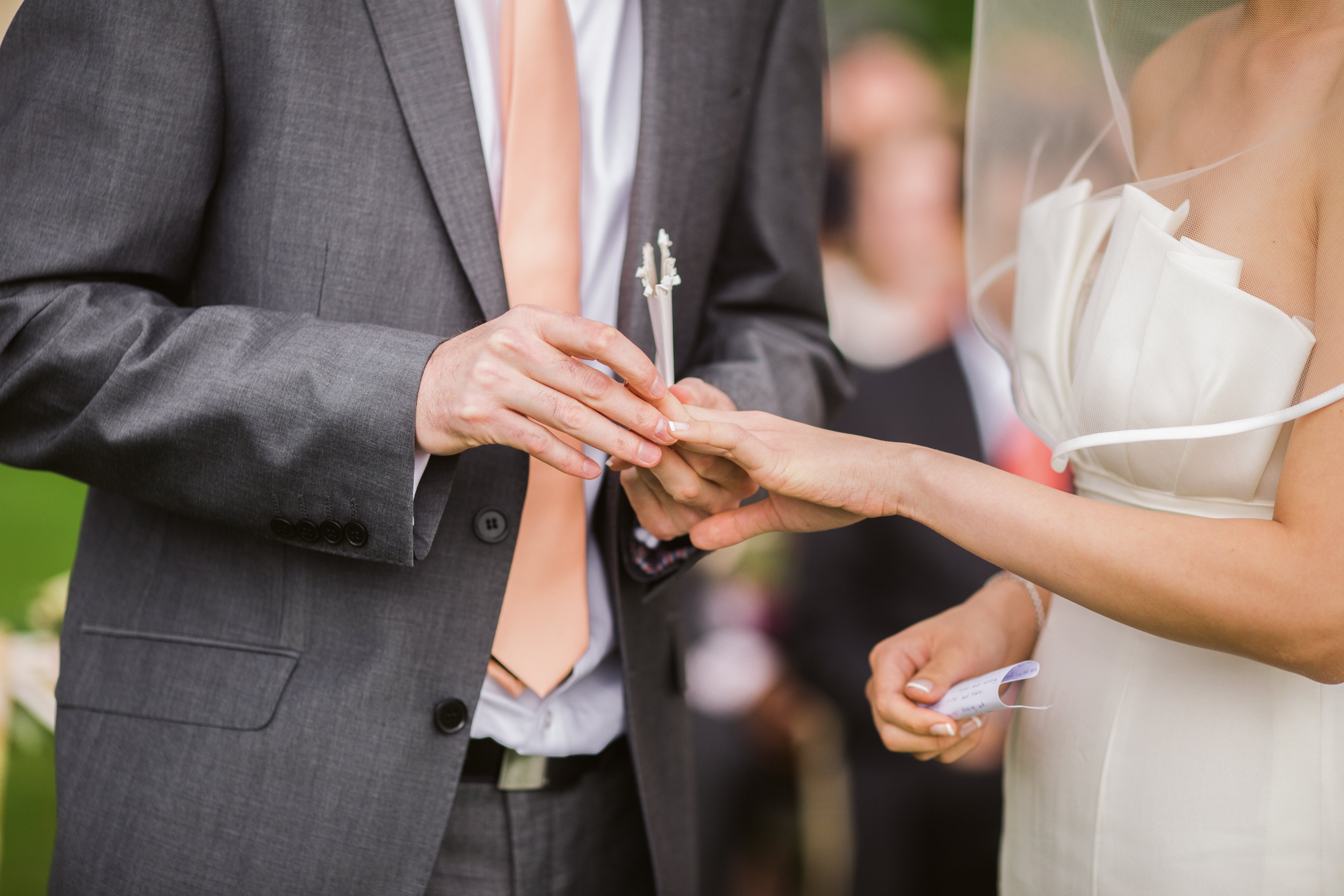 Free Photo of Groom Putting Wedding Ring on His Bride Stock Photo