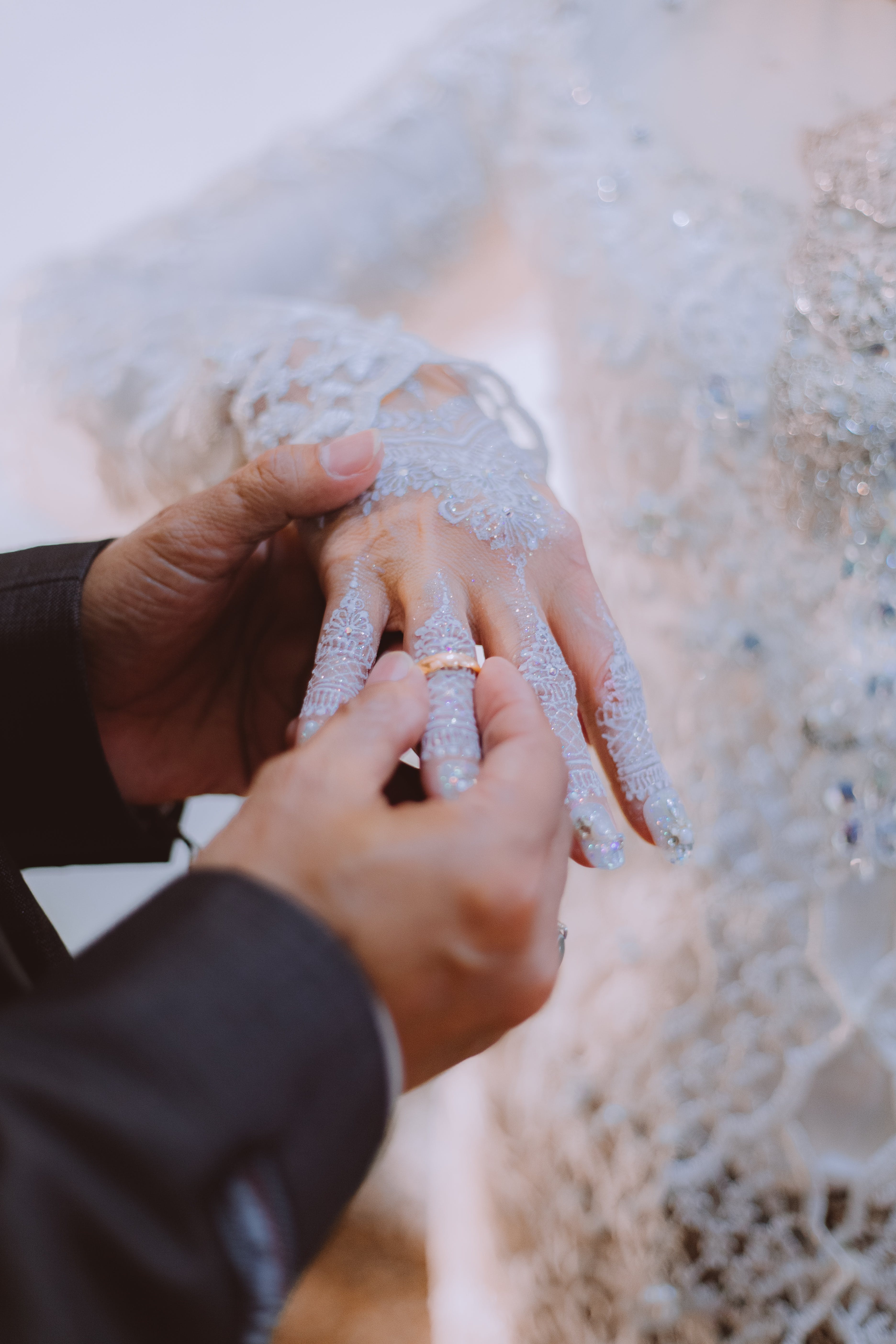 Free Man Putting a Wedding Ring on Bride's Finger Stock Photo